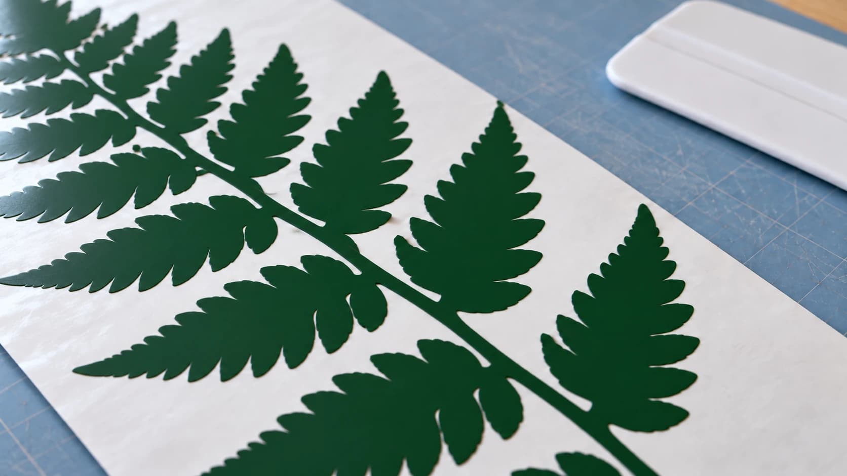 Close view of the same forest-green fern decal weeded on white release liner