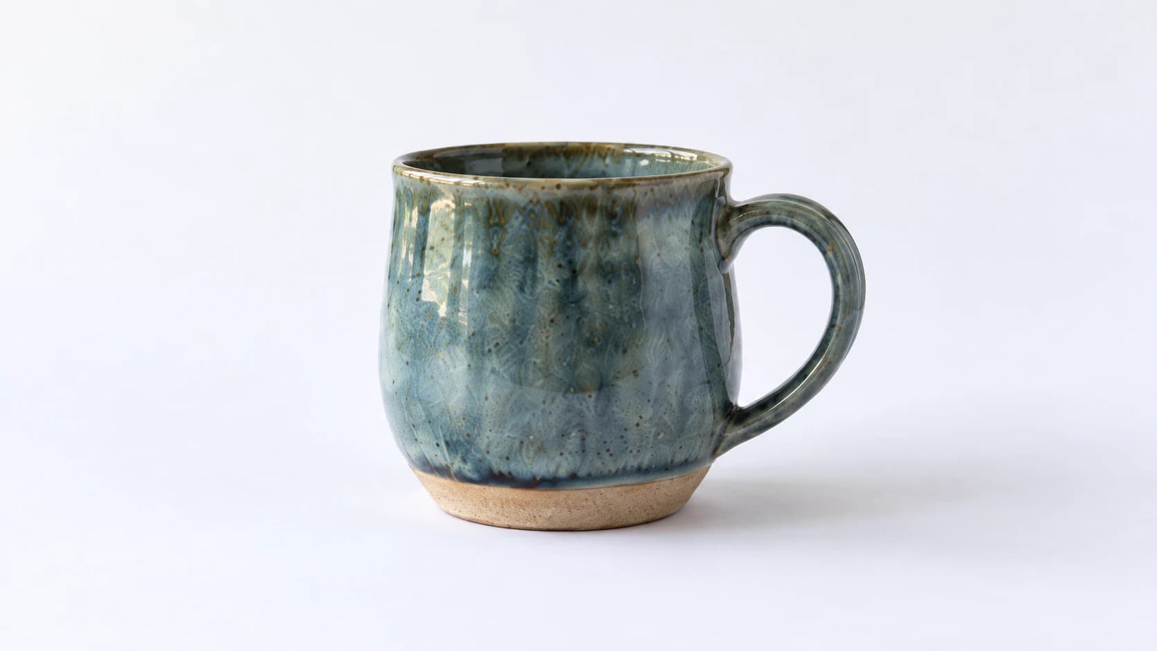 Blue-green glazed mug on the white sweep from the photography setup